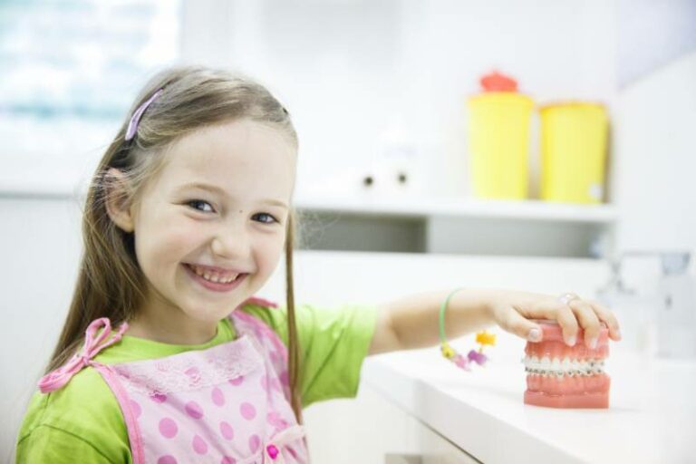 Girl holding model of teeth