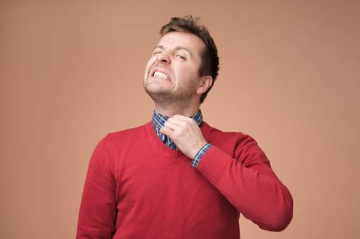 Man in red shirt looking uncomfortable