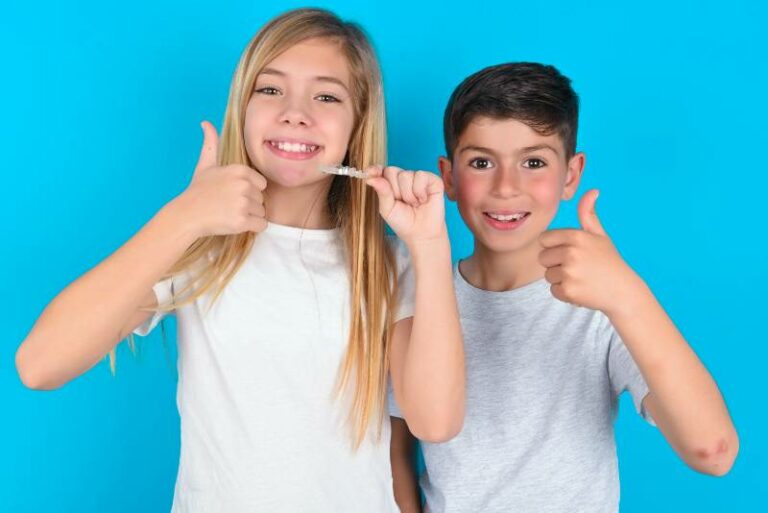 Kids holding clear aligners
